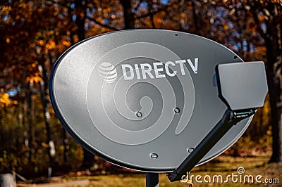 Tiffin, Iowa, USA - 10/2020: Directv satelite dish with fall leaves in background Editorial Stock Photo