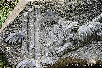 tiger stone carving showing teeth Stock Photo