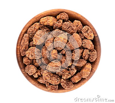 Tigernuts isolated on white background. Chufa nuts or tiger nuts in wooden bowl. Top view Stock Photo