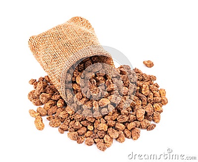 Tigernuts in small burlap sack, isolated on white background. Chufa nuts or tiger nuts Stock Photo