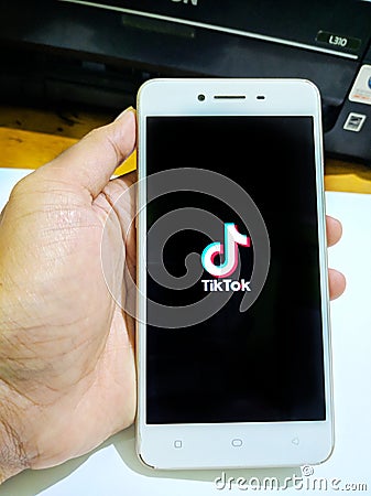 Tik tok application icon on smartphone. Tik tok social media network Editorial Stock Photo