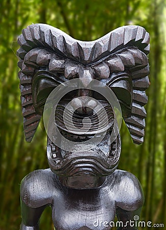 Tiki statue in topical jungle Stock Photo