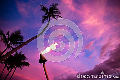 Tiki torch against tropical sunset Stock Photo