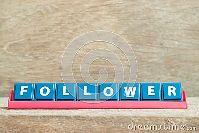 Tile letter with word follower in red color rack on wood background Stock Photo