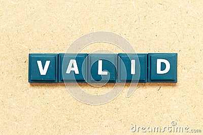 Tile letter in word valid on wood background Stock Photo
