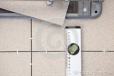 Tile-cutter, building level for tile paving, background Stock Photo