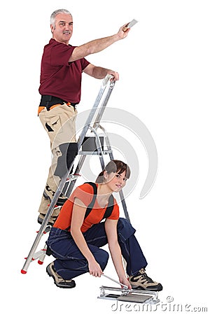Tile fitters at work Stock Photo