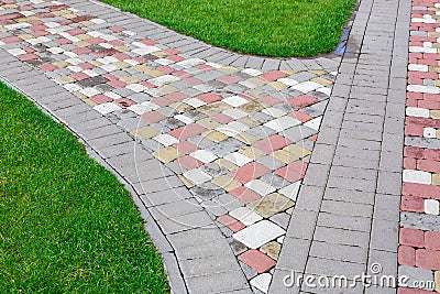 Tile path intersection angle in a park. Stock Photo