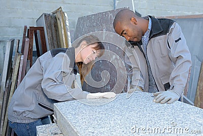 Tile setters inspecting delivery Stock Photo