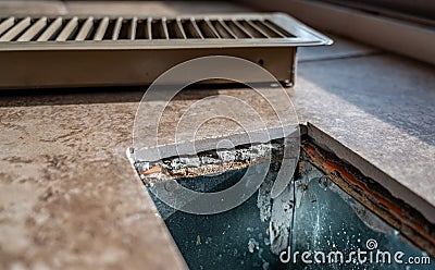 Tiled open floor vent with cover removed Stock Photo