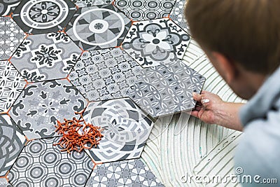 Tiler laying floor tiles Stock Photo