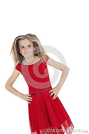 Tilt image of girl in red frock with hands on hips over white background Stock Photo