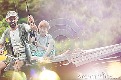 Tilt shot of happy father and son catching fish Stock Photo