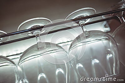 Tilt shot of wineglasses on rack at nightclub Stock Photo