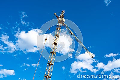 Tilted tower crane to the right against blue sky Stock Photo
