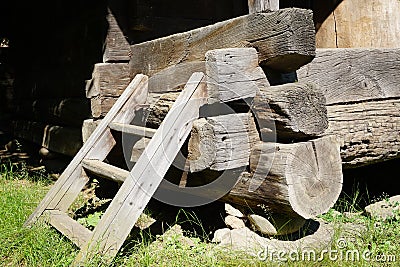 Timber footing beams placed on stone supports, corner detail to rural house Stock Photo