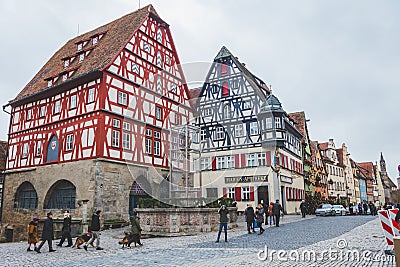 Timber-frame buildings and the Georg Fountain on Marketplatz in Rothenburg ob der Tauber in Germany Editorial Stock Photo