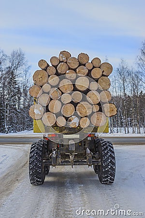 Timber transport on the winter road Stock Photo