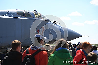 People near the Russian fighter-interceptor MiG-31BM RF-95448 with the airborne number 37 red on a sunny day. Close-up Editorial Stock Photo