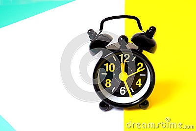 Vintage black alarm clock on multicolored background Stock Photo