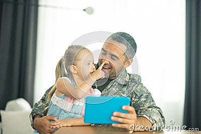 Member of the armed forces coming home and spending time with daughter Stock Photo