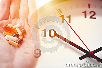Time of day to take a drug multi-dose medication concept. various assorted medicine pills tablet overlay clock face Stock Photo
