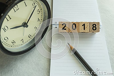 2018 time and deadline concept with wooden blocks number and clock with note paper and pencil Stock Photo