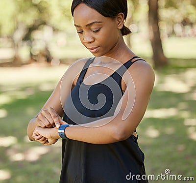 Time, fitness or black woman in nature with a smartwatch to monitor heart health in training, exercise or park workout Stock Photo