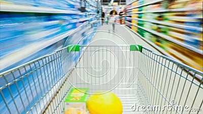 Time Lapse of the Shopping Cart Moving Between Various Aisles and Section in the Big Supermarket. Inside Trolley Various Stock Photo