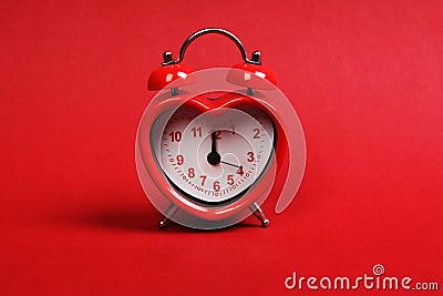 Time for love. Red heart shaped alarm clock on red background Stock Photo