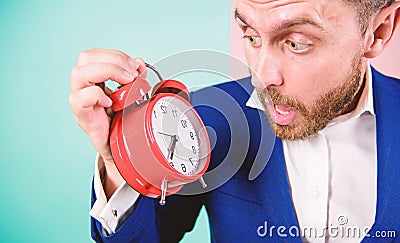 Time management skills. How much time left till deadline. Time to work. Man bearded surprised businessman hold clock Stock Photo