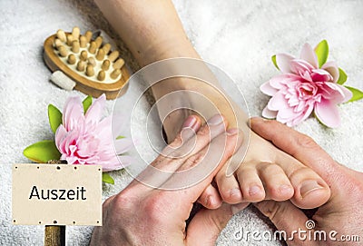 Time out with a foot massage sign in german Stock Photo