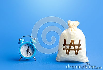 Time and south korean won money bag. Loans, mortgages. Deposits, savings. Retirement funds. Bank, finance. Investments. Hourly pay Stock Photo