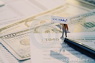 Time for tax concept, miniature figurine holding sign I& x27;m ready Editorial Stock Photo