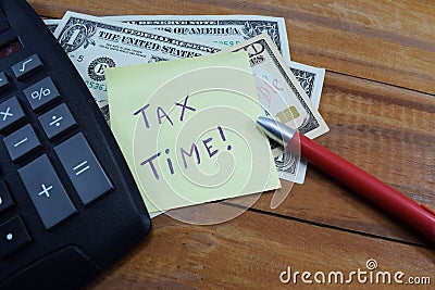 Time taxes, on the table is a calculator and money dollars Stock Photo