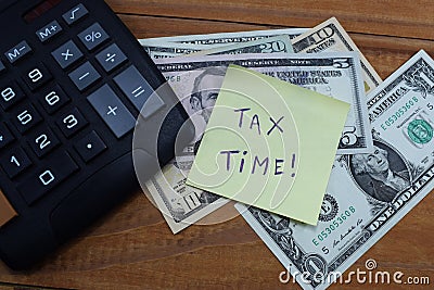 Time taxes, on the table is a calculator and money dollars Stock Photo