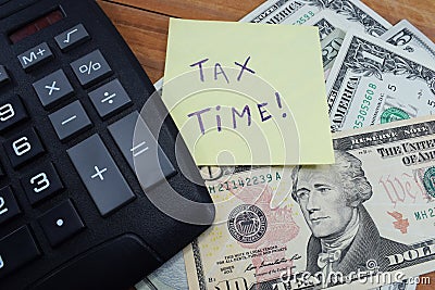 Time taxes, on the table is a calculator and money dollars Stock Photo