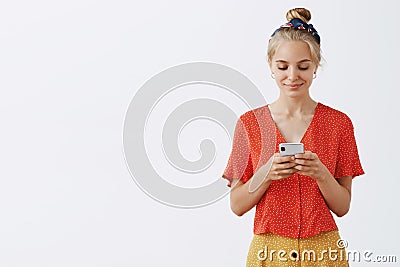 Time to answer my followers. Portrait of relaxed, pleased and calm good-looking blond woman in v-neck vintage polka-dot Stock Photo