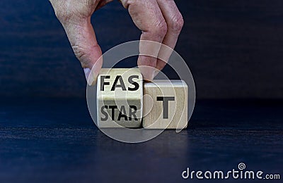 Time to fast start symbol. Businessman turns a wooden cube with words `fast start`. Beautiful grey background, copy space. Stock Photo