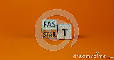 Time to fast start symbol. Turned a wooden cube with words `fast start`. Beautiful orange table, orange background, copy space. Stock Photo