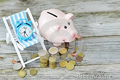 Time to invest your savings concept with pile of money , alarm clock and piggy bank Stock Photo