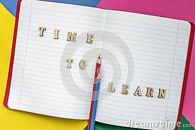 Time to learn, text and colorful crayons in an open notebook. Concept of education, starting school, back to school. Stock Photo