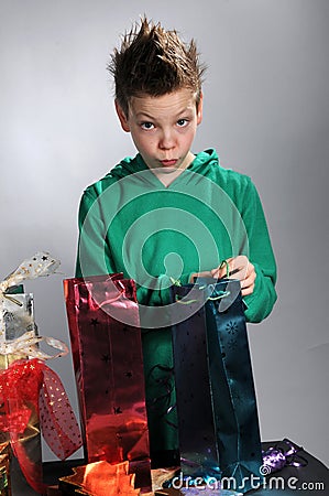Boy wrapping up christmas gifts Stock Photo