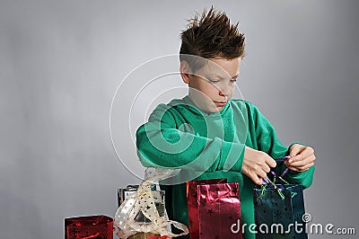 Boy wrapping up christmas gifts Stock Photo