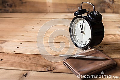 Time to payment concept. retro bell clock timed at 11 o`clock on wood background Stock Photo