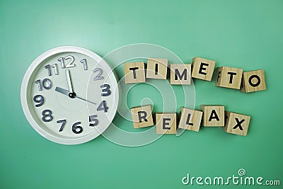 Time To Relax alphabet letter with alarm clock on wooden background Stock Photo