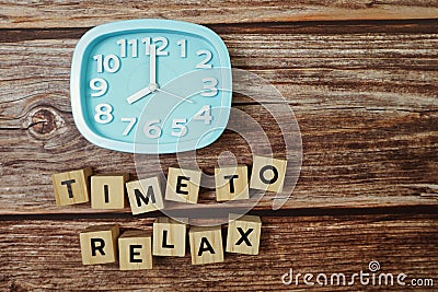 Time To Relax alphabet letter with alarm clock on wooden background Stock Photo