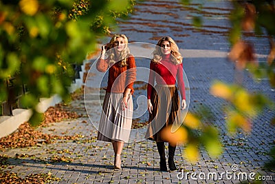 Time to relax. girls in corrugated skirt and sweater. female beauty. real femininity. autumn women outdoor. girl friends Stock Photo