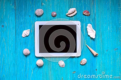 Time to rest, tablet, seashells, blue wood background, Stock Photo