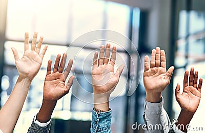 Time to start asking important questions. a group of unrecognizable businesspeople raising their hands. Stock Photo